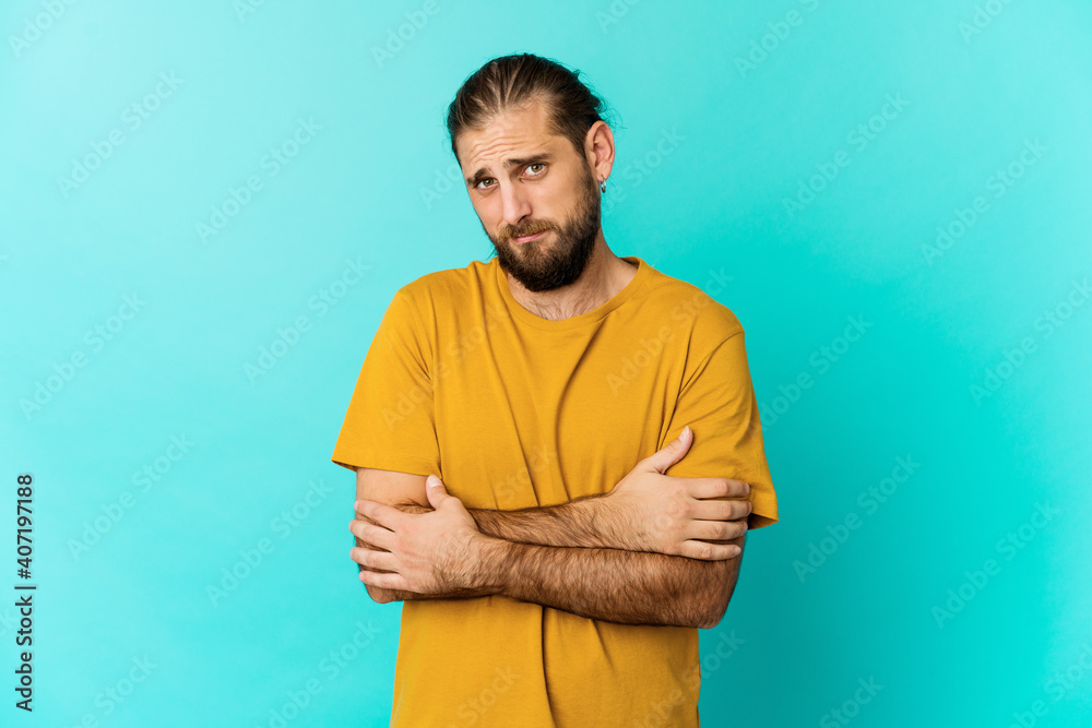 Young man with long hair look unhappy looking in camera with sarcastic expression. Young man with long hair look unhappy looking in camera with sarcastic expression.