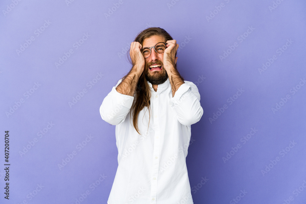 Young man with long hair look crying, unhappy with something, agony and confusion concept. Young man with long hair look crying, unhappy with something, agony and confusion concept.