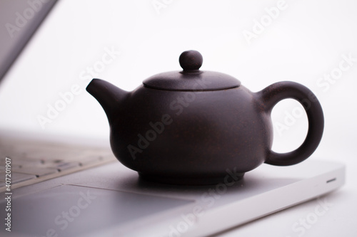 A teapot on the computer keyboard,close-up photo