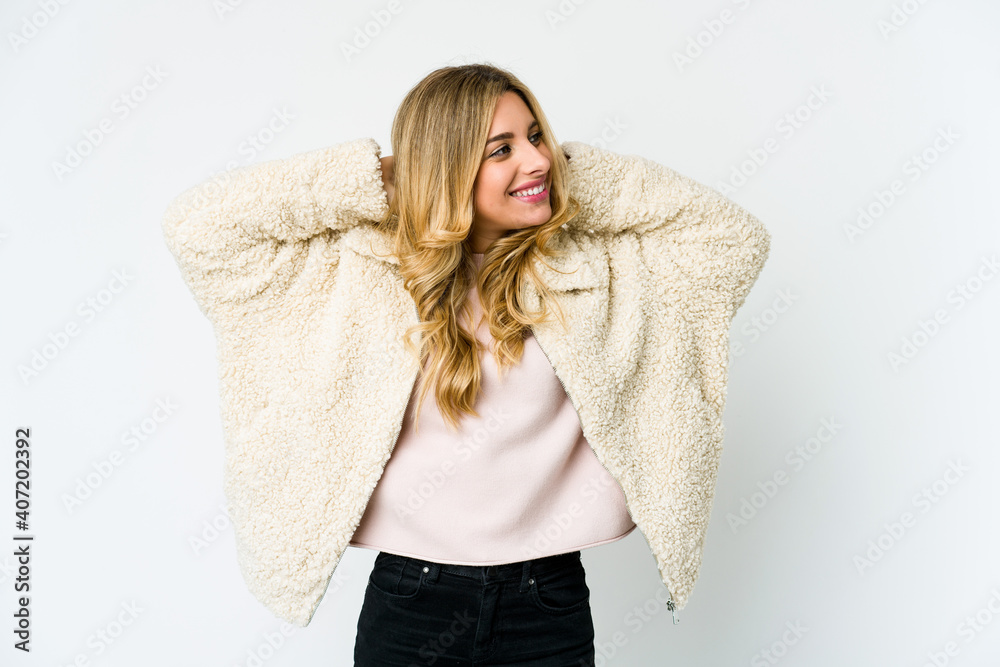 Young caucasian blonde woman feeling confident, with hands behind the head.