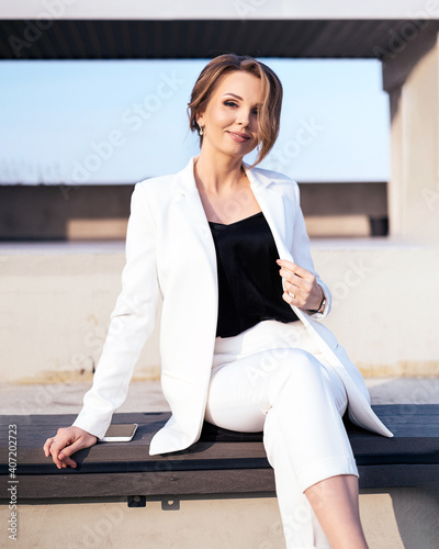 Εκτύπωση καμβά young business woman in white pantsuit