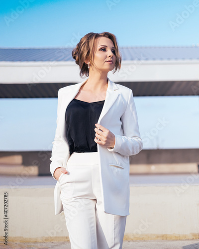 young business woman in white pantsuit