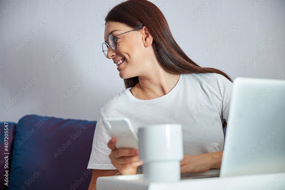 Cheerful female spending time with notebook indoors Cheerful female spending time with notebook indoors
