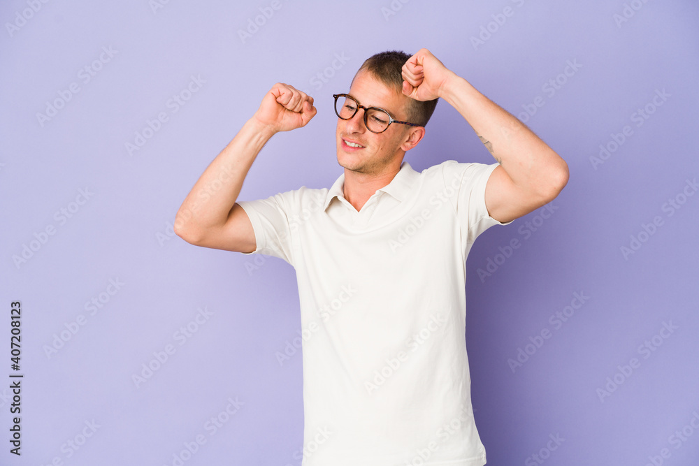 Naklejka premium Young caucasian handsome man celebrating a special day, jumps and raise arms with energy.