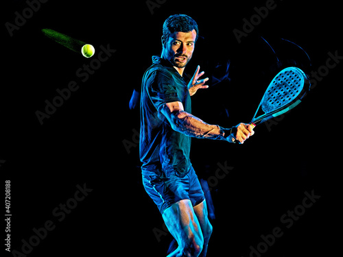 one caucasian Paddle tennis player man studio shot isolated on black background with light painting blur effect photo