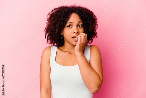 Young african american mixed race woman isolated biting fingernails, nervous and very anxious. © Asier