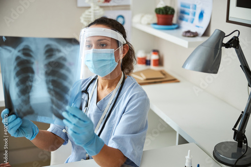 Medical worker looking for the abnormalities in an x-ray