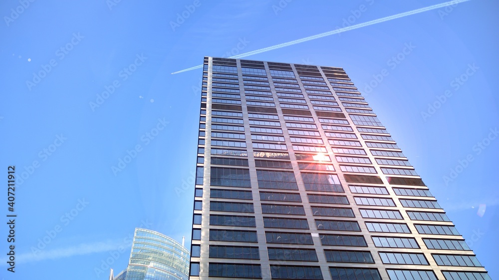 Concept for real estate and corporate construction..The modern office building of the orange morning sun in the sky background. Concept for real estate and corporate construction..The modern office building of the orange morning sun in the sky background.