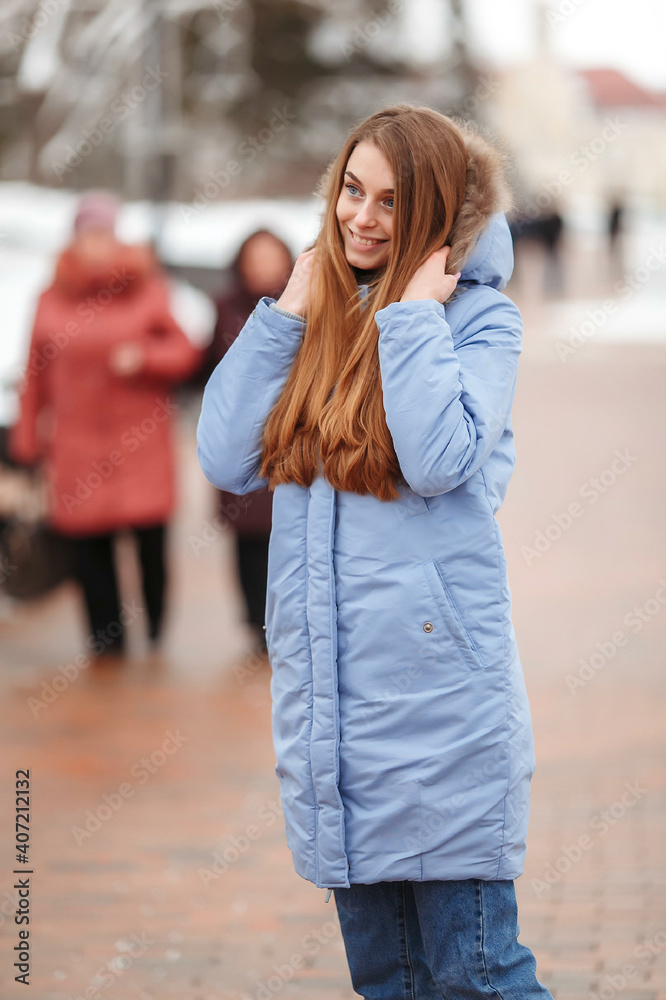 young woman are walking in the winter park. Winter park in the snow. Clothing advertising photo concept