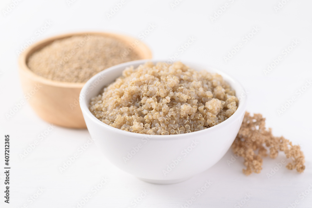 Cooked brown quinoa seeds and raw quinoa seeds in a bowl on white background, Healthy vegan food Cooked brown quinoa seeds and raw quinoa seeds in a bowl on white background, Healthy vegan food