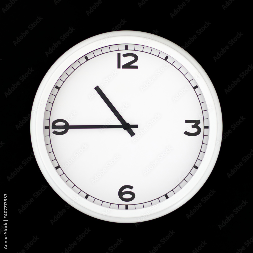White round analog wall clock isolated on black background. White round analog wall clock isolated on black background.