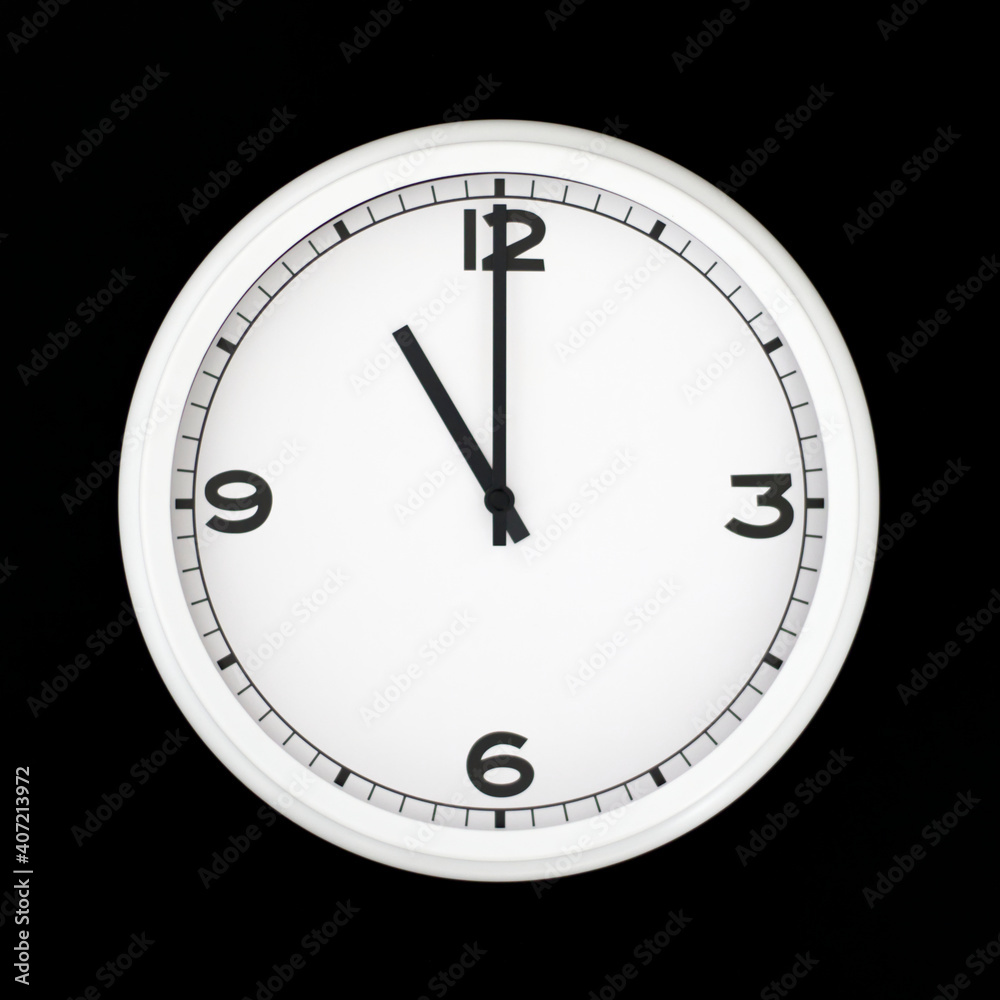 White round analog wall clock isolated on black background. White round analog wall clock isolated on black background.