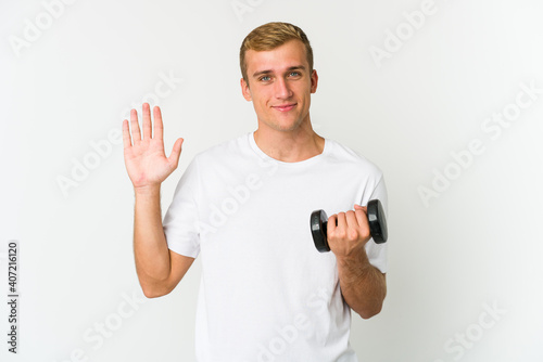 Young caucasian man holding a weight isolated on white background