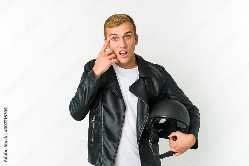 Young caucasian man holding a motorbike helmet isolated on white background Young caucasian man holding a motorbike helmet isolated on white background