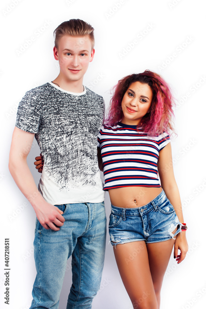 young pretty teenage couple, hipster blond guy with his mixed raced girlfriend happy smiling and hugging isolated on white background, lifestyle people concept young pretty teenage couple, hipster blond guy with his mixed raced girlfriend happy smiling and hugging isolated on white background, lifestyle people concept