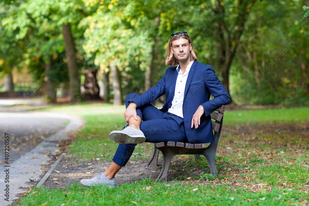 Portrait of young handsome stylish man. Outdoor fashion portrait.