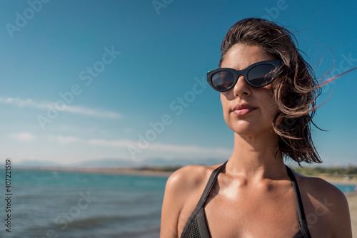 Beautiful young female in bikini on gorgeous sandy beach enjoying summertime vacation © Vladimir Borovic