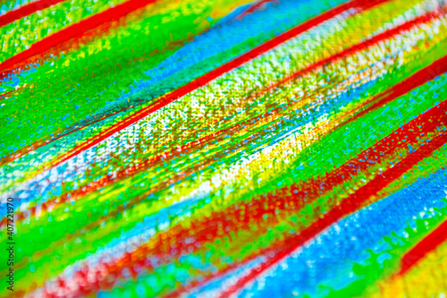 Many different multi-colored lines are chaotically drawn with brush