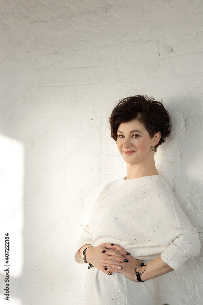 An active, beautiful, middle-aged woman. Close-up of a woman's face with a smile. Mature healthy woman for advertising in the studio on a white background An active, beautiful, middle-aged woman. Close-up of a woman's face with a smile. Mature healthy woman for advertising in the studio on a white background