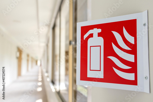 Close up fire extinguisher sign in the building corridor. Selective focus image. Emergency sign.