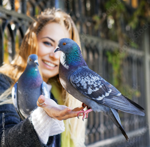 photo of Girl and doves. feeding pigeons in the park
