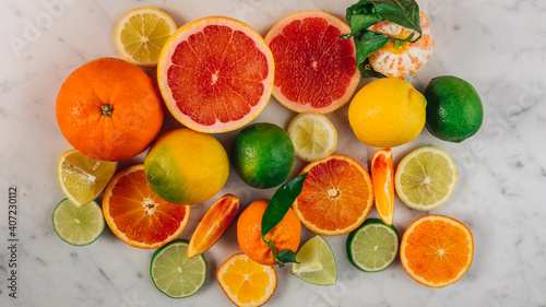 Colorful fruit background top view. Mix of red orange, lime, lemon, grapefruit are on white background. Fresh citrus fruit rich of vitamins, juicy fruit, healthy nutrition.