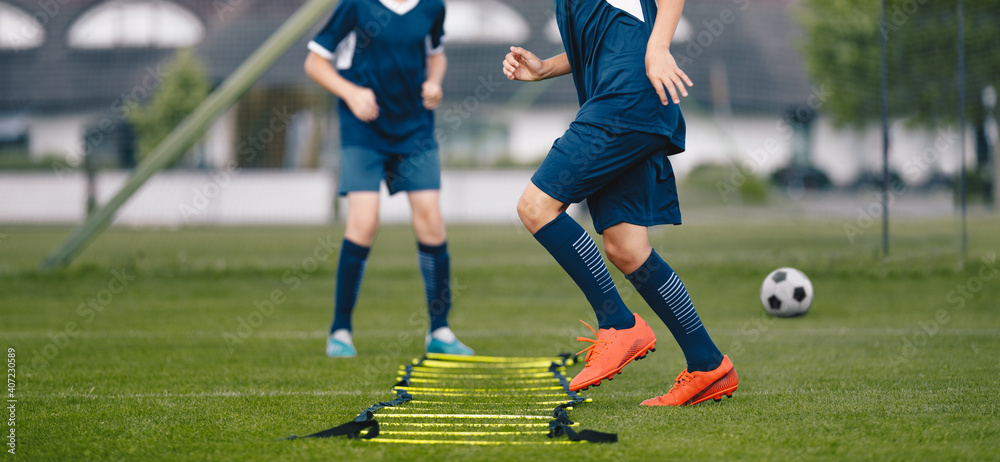 Soccer Ladder Drill. Young Football Boy Exercise on Ladder. Kids on Soccer Summer Camp Soccer Ladder Drill. Young Football Boy Exercise on Ladder. Kids on Soccer Summer Camp