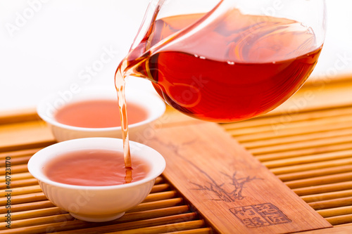 Tea pouring into tea cup