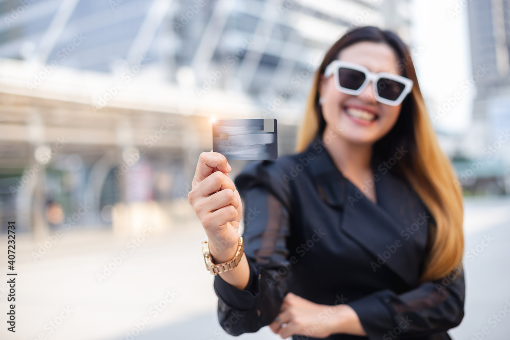 Fototapeta premium Close up credit card use instead of cash showing by woman,