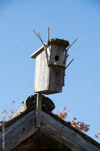 Wooden bird house on the roof