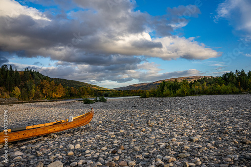 Fototapeta Naklejka Na Ścianę i Meble -  Wooden boats on stones on ariver in Norway