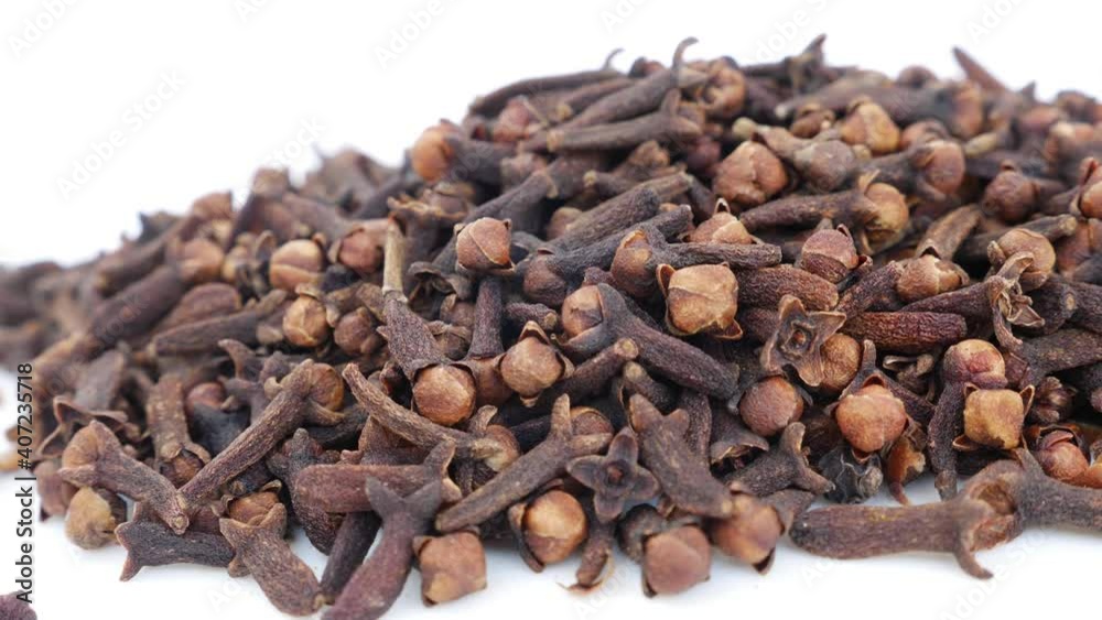 View of cloves placed over a white background View of cloves placed over a white background