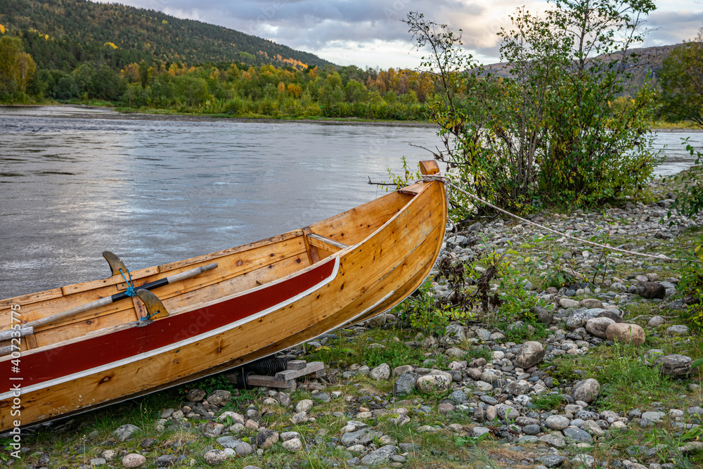 Wooden boats on stones on ariver in Norway