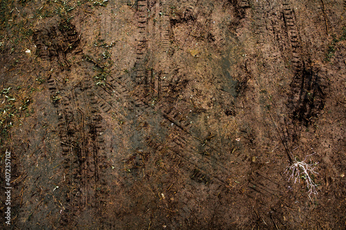 Tyre track on dirt sand or mud, Picture in retro or grunge tone. Car drive on sand. off road track. Track on grass field. Track in farm.