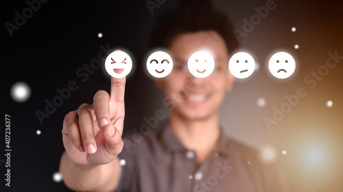 Businessman pressing feeling icon on face from a virtual screen. Ideas about satisfaction and opinions. Technology effects.