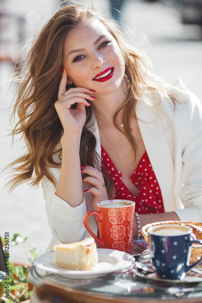 Beautiful woman at the caffeteria. Closeup portrait of attractive blond female outdoors