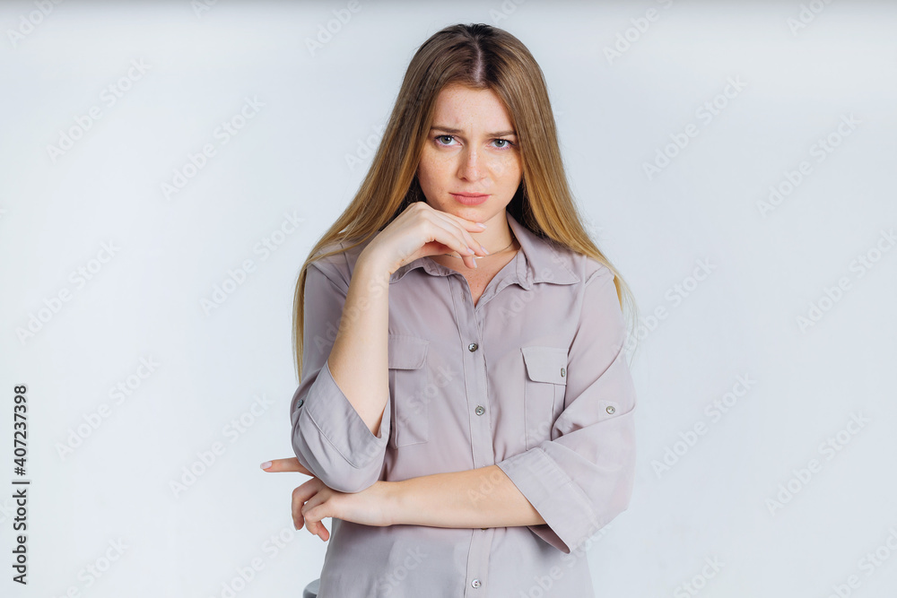 Beautiful girl holding chin with sad and upset facial expression, unhappy Beautiful girl holding chin with sad and upset facial expression, unhappy