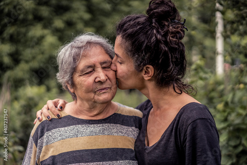 Young woman and her grandmother, very old woman. Two generations. Family love.
