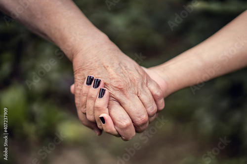 Elderly care. Holding hands old and young person © Vladimir Borovic