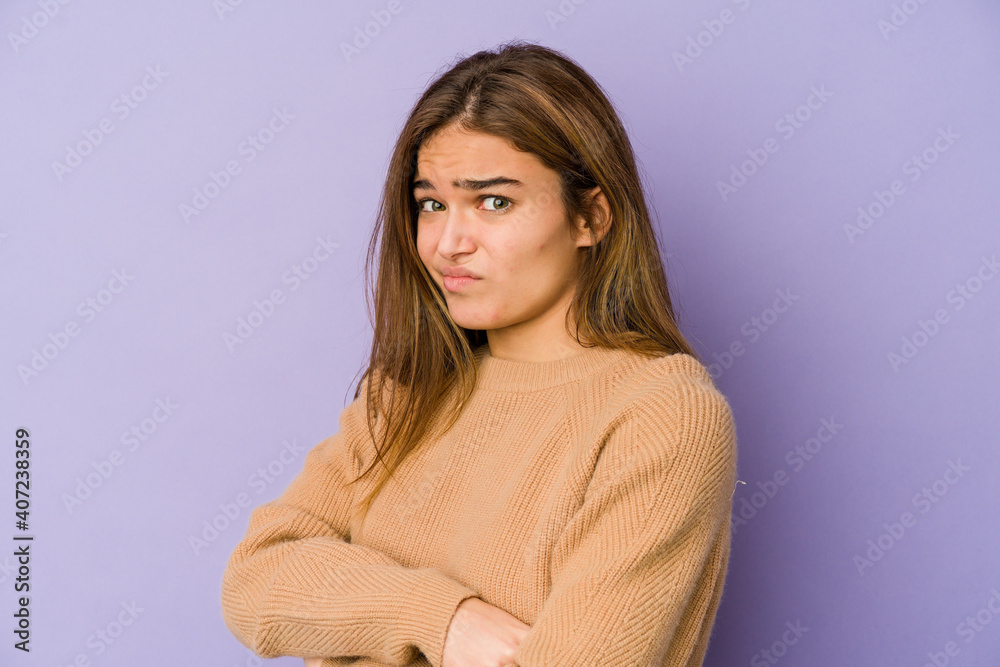 Young skinny caucasian girl teenager on purple background unhappy looking in camera with sarcastic expression. Young skinny caucasian girl teenager on purple background unhappy looking in camera with sarcastic expression.