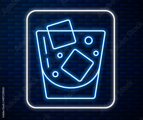 Glowing neon line Glass of whiskey and ice cubes icon isolated on brick wall background. Vector.
