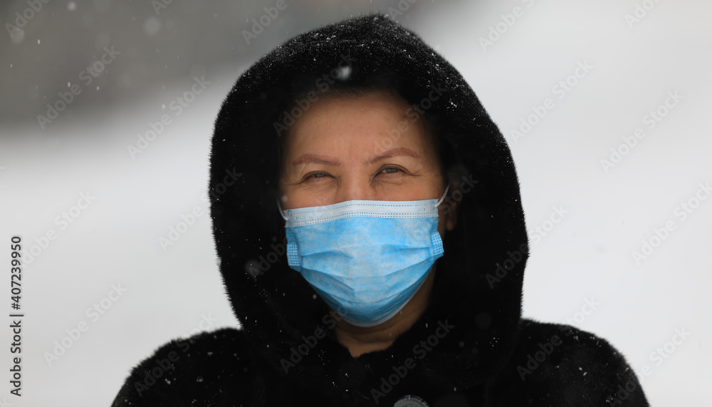 old woman in a black mink coat wearing a medical mask old woman in a black mink coat wearing a medical mask