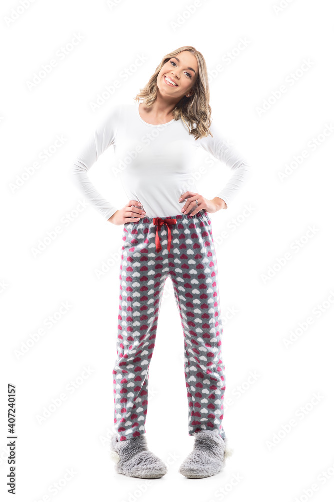 Cute playful happy young innocent woman in pajama and fluffy slippers  standing in pigeon-toed pose. Full length portrait on white background.  Stock Photo | Adobe Stock