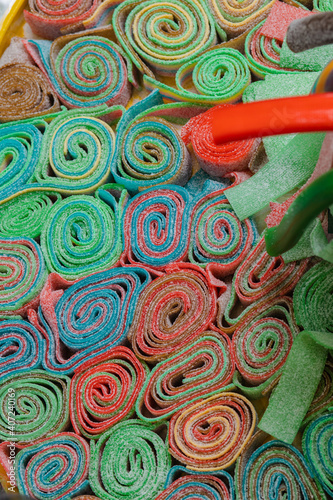 Sweet gummy multicolored sticks on a funfair stand