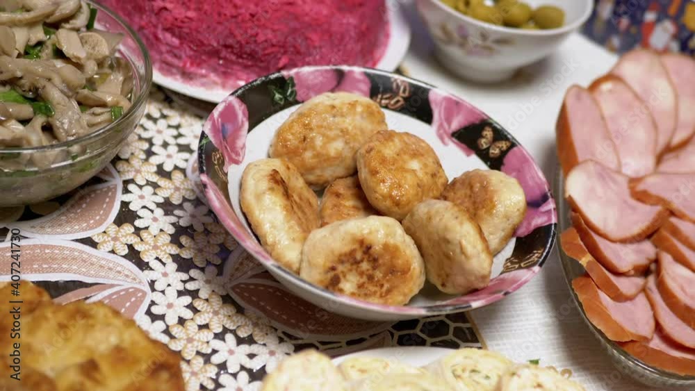Festive Dishes of Christmas Table with Traditional Food. Chops, Salads, Rolls Festive Dishes of Christmas Table with Traditional Food. Chops, Salads, Rolls