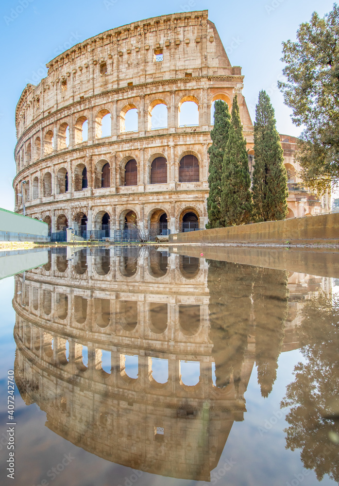 Rome, Italy - in Winter time, frequent rain showers create pools in which the wonderful Old Town of Rome reflect like in a mirror. Here in particular the Colosseum