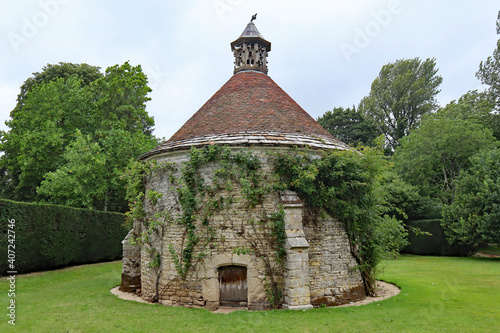 DORCHESTER, DORSET, UK - AUGUST 21ST 2020: A dovecote with ivy growing on it, stands in the ground of an English stately home photo