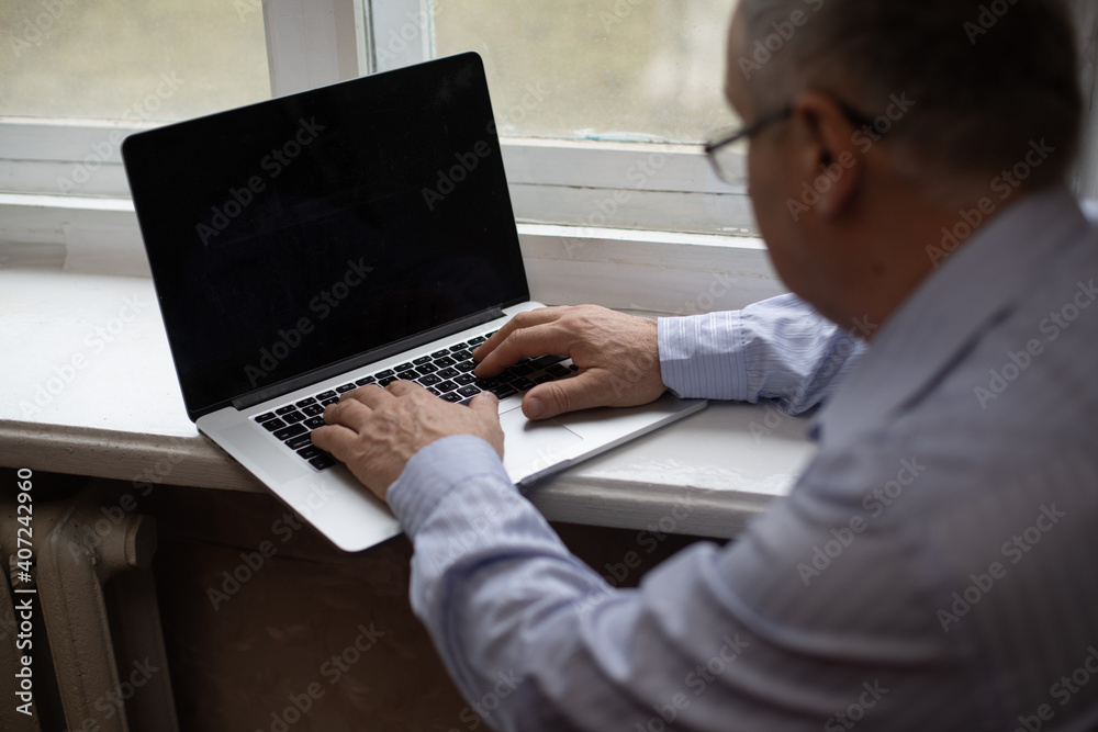 Senior Man Video Conferencing On Laptop Over Wooden Desk Senior Man Video Conferencing On Laptop Over Wooden Desk