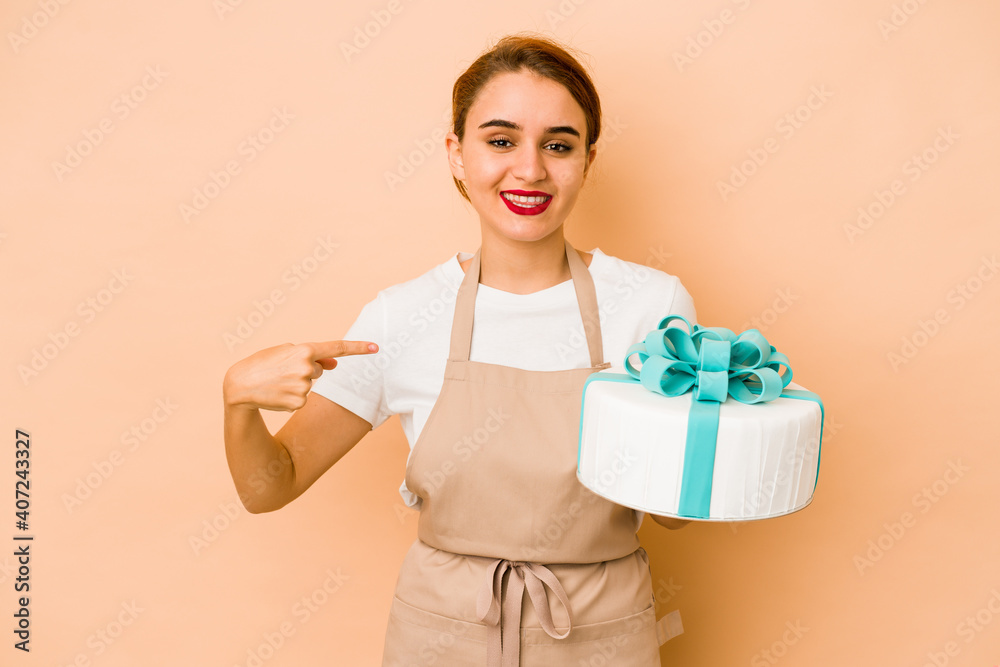 Young skinny arab pastry chef woman person pointing by hand to a shirt copy space, proud and confident Young skinny arab pastry chef woman person pointing by hand to a shirt copy space, proud and confident