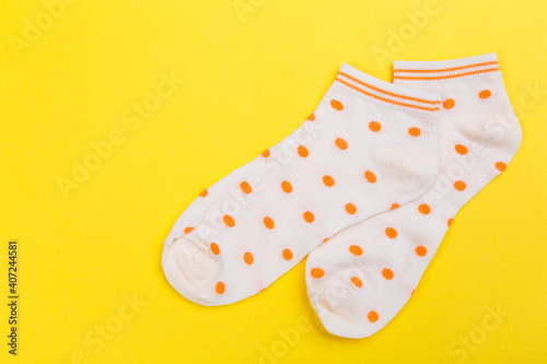 Top view of a pair of colored socks on a yellow background. Clothing in the form of socks.